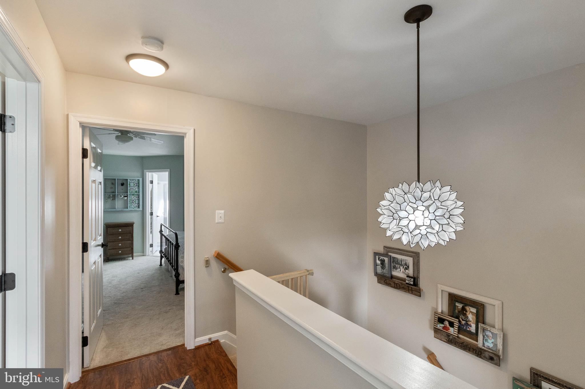 20385 Farmgate Terrace Ashburn, VA 20147 - Photo 15 of 27 a living room with furniture and a chandelier