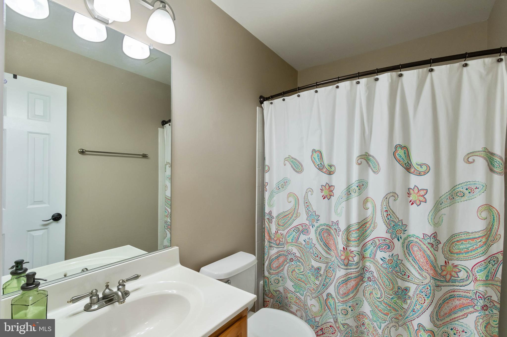 20385 Farmgate Terrace Ashburn, VA 20147 - Photo 17 of 27 a bathroom with a sink and mirror with toilet
