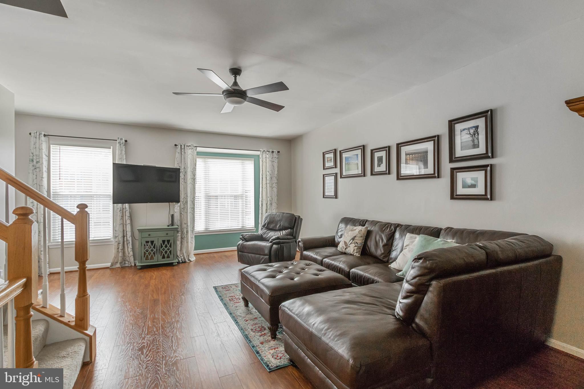 20385 Farmgate Terrace Ashburn, VA 20147 - Photo 5 of 27 a living room with furniture and a flat screen tv