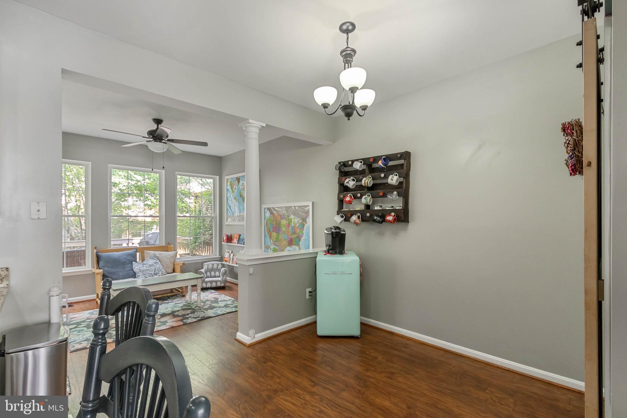 20385 Farmgate Terrace Ashburn, VA 20147 - Photo 8 of 27 a living room with furniture chandelier and a window