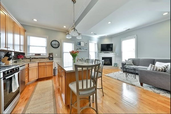 a kitchen with a table chairs stove and cabinets