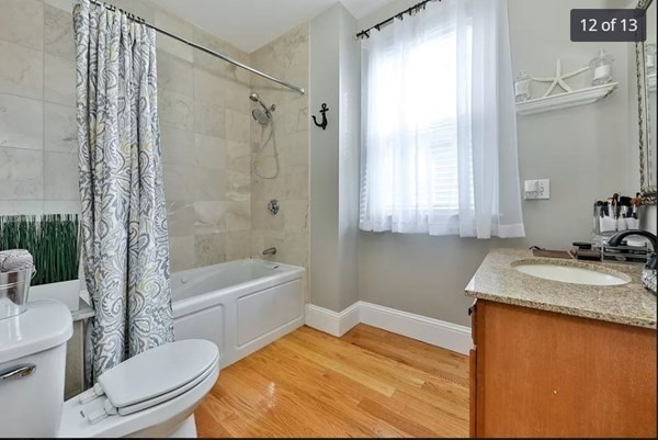 62 H Street, Unit 2 Boston, MA 02127 - Photo 11 of 12 a bathroom with a granite countertop sink toilet and shower