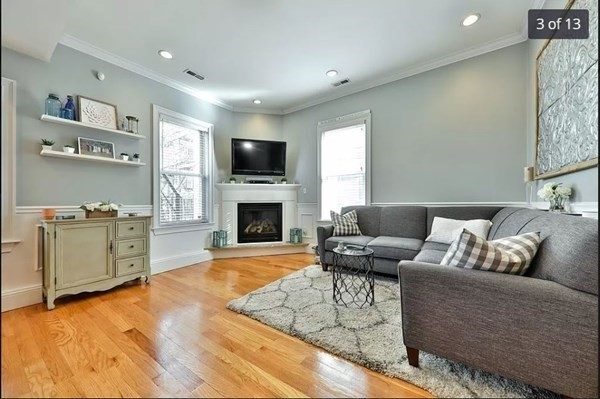 62 H Street, Unit 2 Boston, MA 02127 - Photo 3 of 12 a living room with furniture a fireplace and a flat screen tv