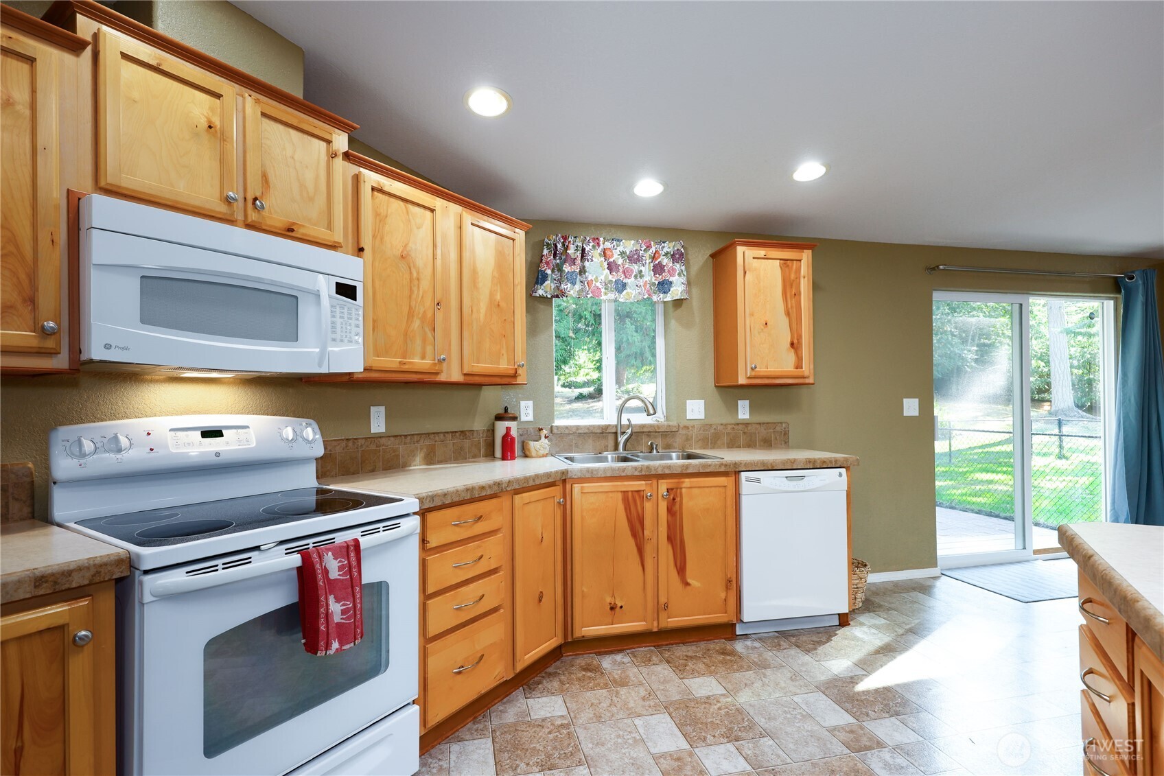 35025 Little Boston Road Northeast Kingston, WA 98346 - Photo 14 of 40 a kitchen with stainless steel appliances granite countertop a stove a sink and a microwave