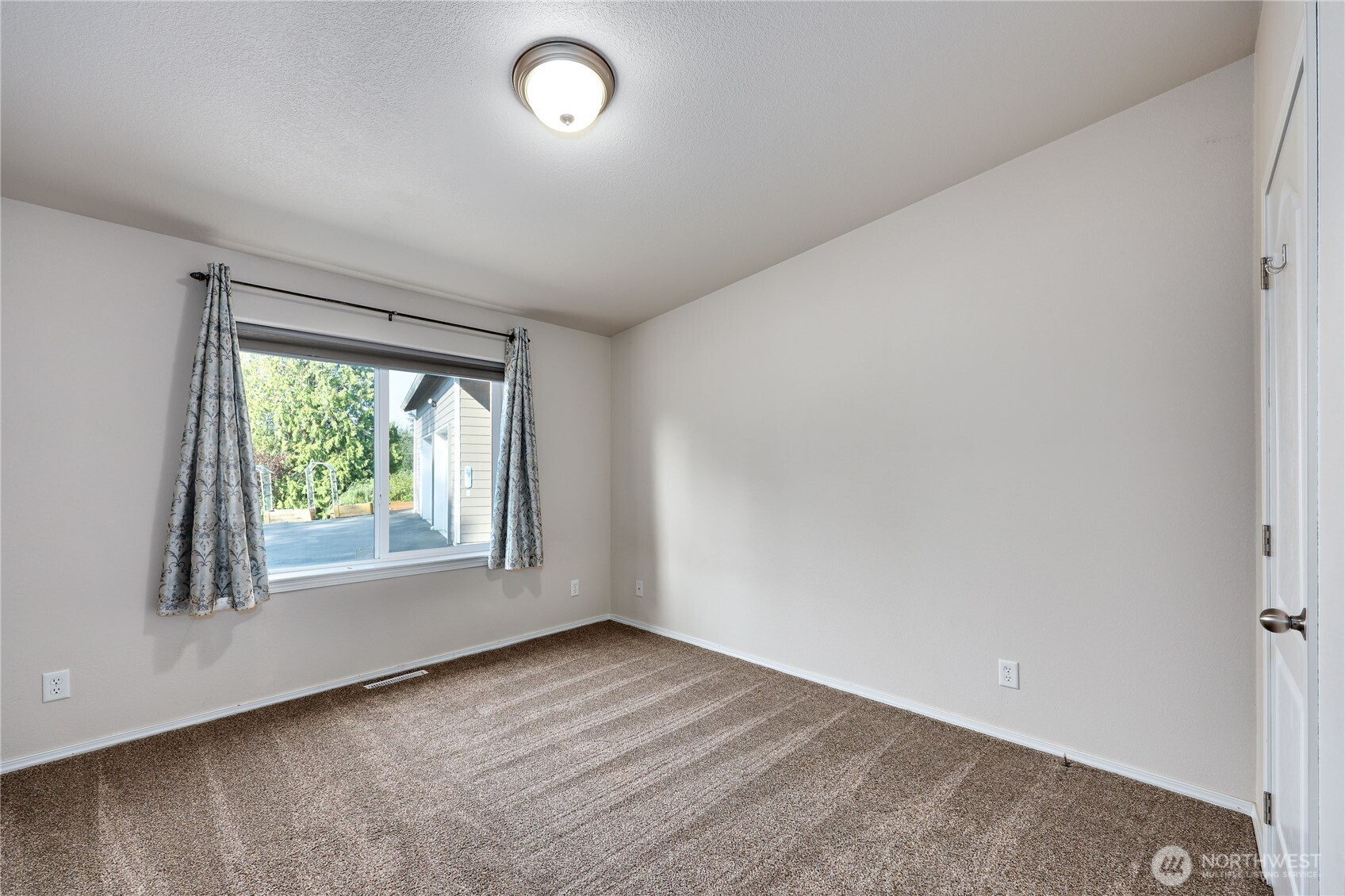35025 Little Boston Road Northeast Kingston, WA 98346 - Photo 20 of 40 an empty room with wooden floor and windows