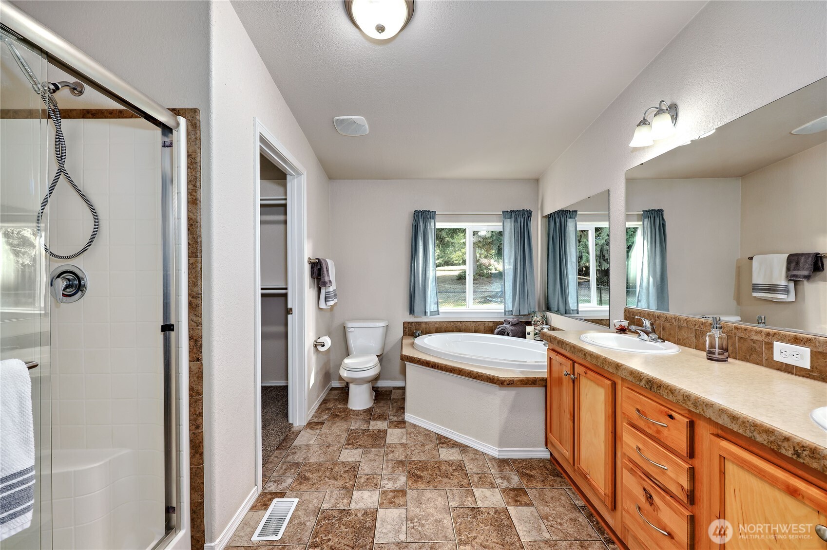35025 Little Boston Road Northeast Kingston, WA 98346 - Photo 24 of 40 a spacious bathroom with a granite countertop tub sink and mirror
