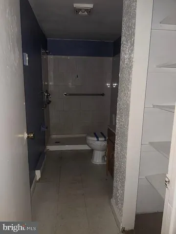 a bathroom with a toilet and a shower