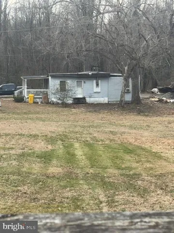 a backyard of house with large trees