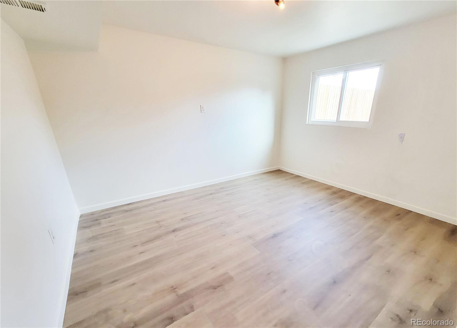 8128 Lafayette Street Denver, CO 80229 - Photo 13 of 19 an empty room with a window