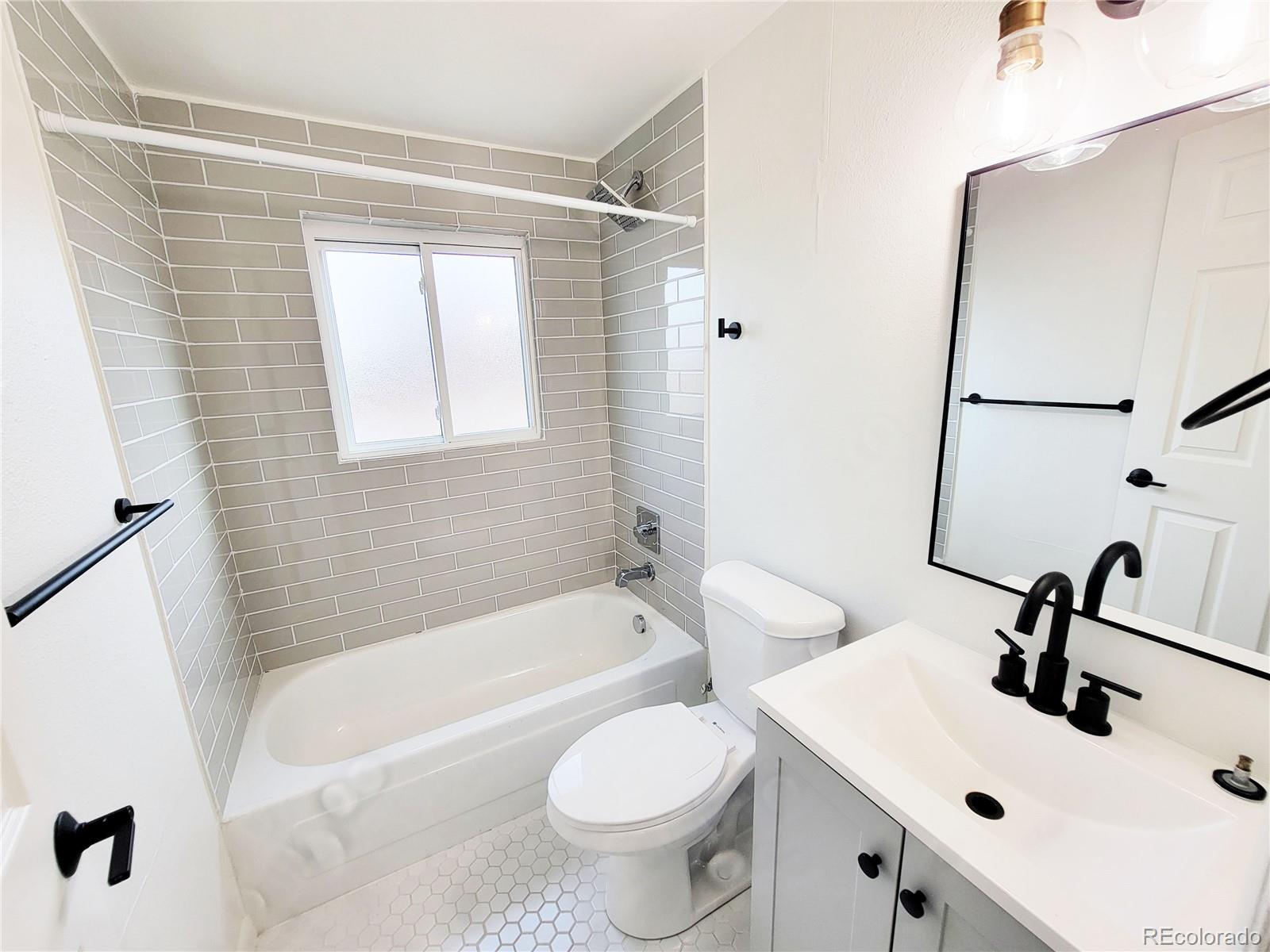 8128 Lafayette Street Denver, CO 80229 - Photo 15 of 19 a bathroom with a sink toilet and shower