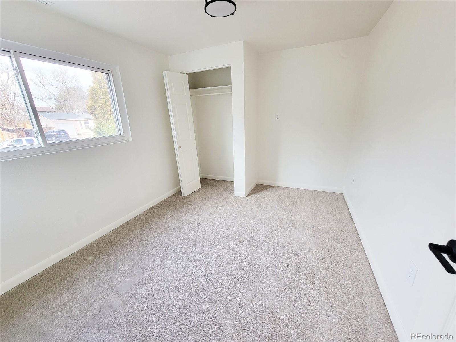 8128 Lafayette Street Denver, CO 80229 - Photo 16 of 19 an empty room with windows