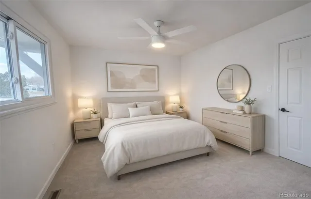 a bedroom with bed and a chandelier