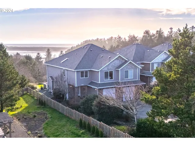 a aerial view of a house next to a yard