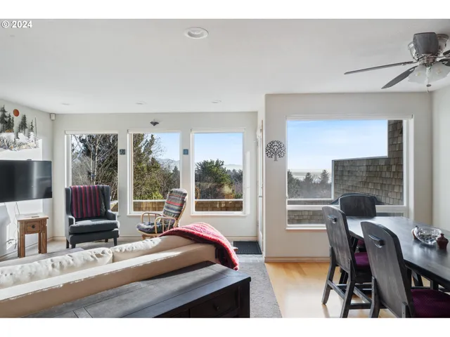 a view of a livingroom with furniture and a large window