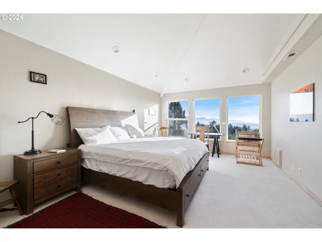 a bed room with a bed and a chair