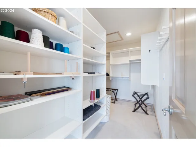 a view of a hallway with wooden floor and windows