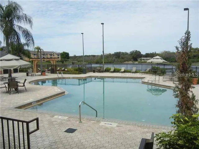 a view of a lake with a table and chairs