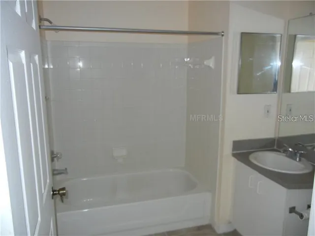 a bathroom with a shower and a sink
