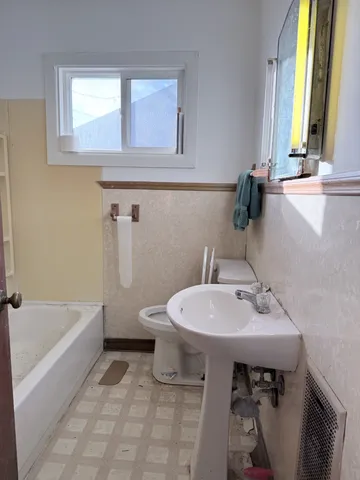 a bathroom with a sink a toilet and bathtub