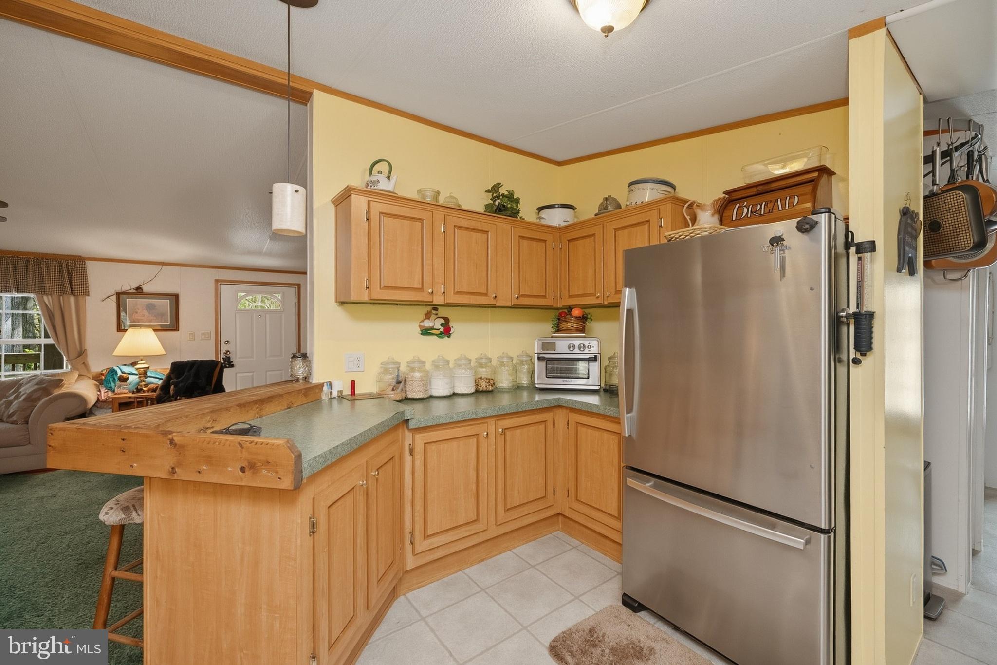 2461 Old Morgantown Road East Accident, MD 21520 - Photo 14 of 50 a kitchen with stainless steel appliances granite countertop a refrigerator a sink and white cabinets