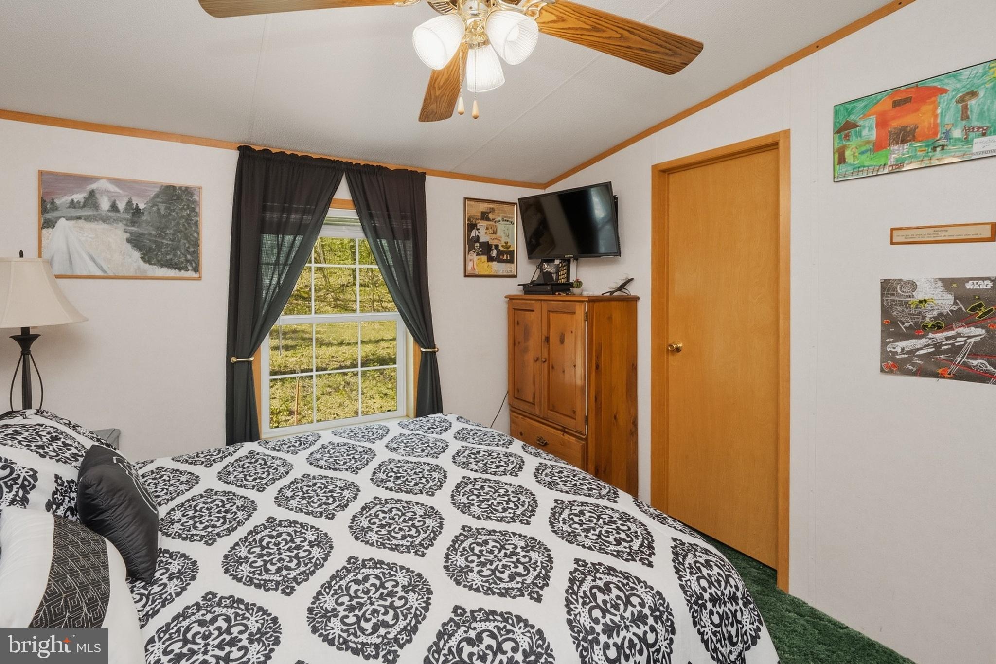 2461 Old Morgantown Road East Accident, MD 21520 - Photo 28 of 50 a bedroom with a bed and a chandelier