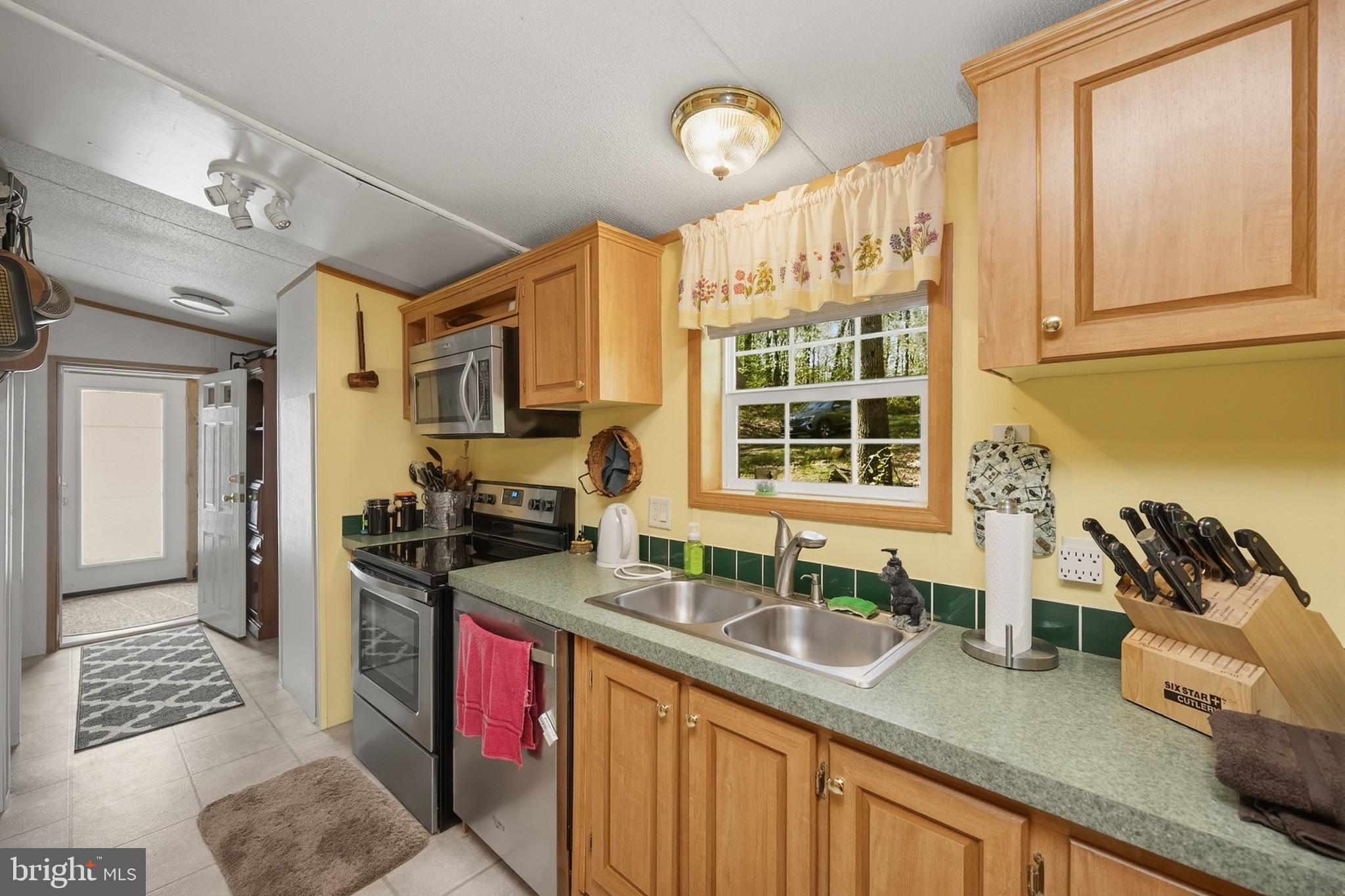 2461 Old Morgantown Road East Accident, MD 21520 - Photo 7 of 50 a kitchen with stainless steel appliances granite countertop a sink stove and cabinets