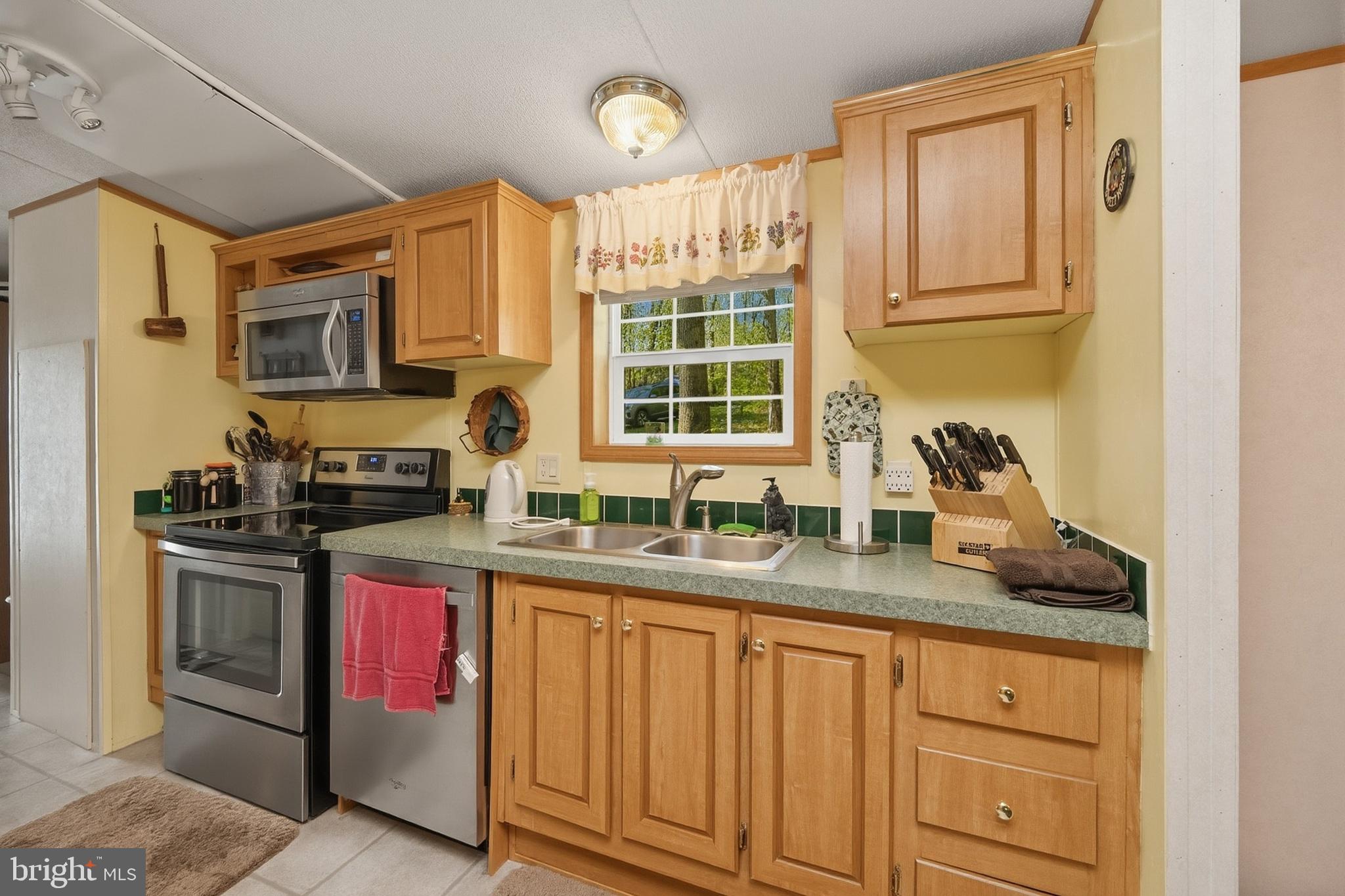 2461 Old Morgantown Road East Accident, MD 21520 - Photo 10 of 50 a kitchen with stainless steel appliances granite countertop a sink stove and cabinets