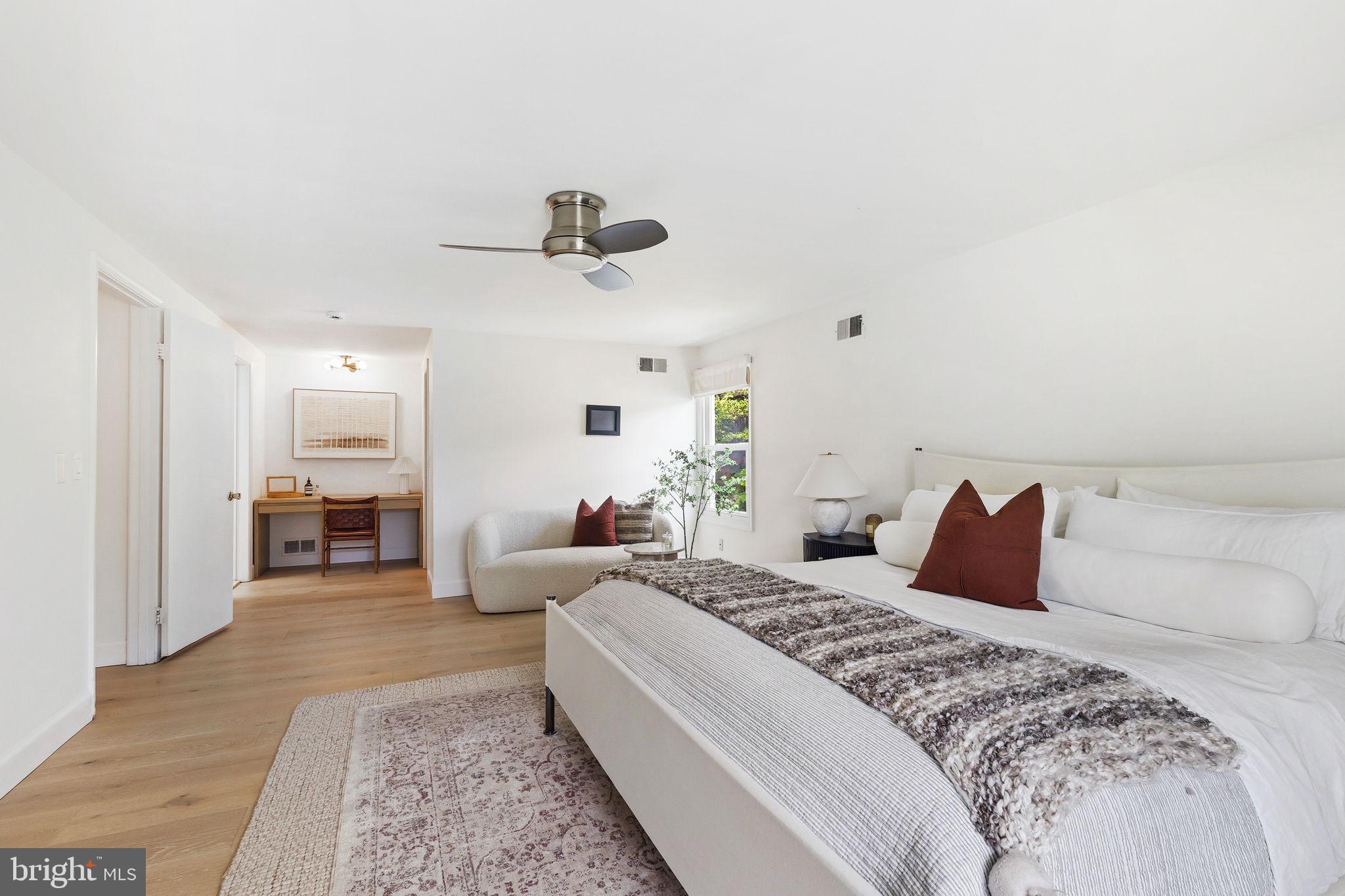 10900 Gainsborough Road Potomac, MD 20854 - Photo 26 of 44 a bedroom with a large bed and a chandelier