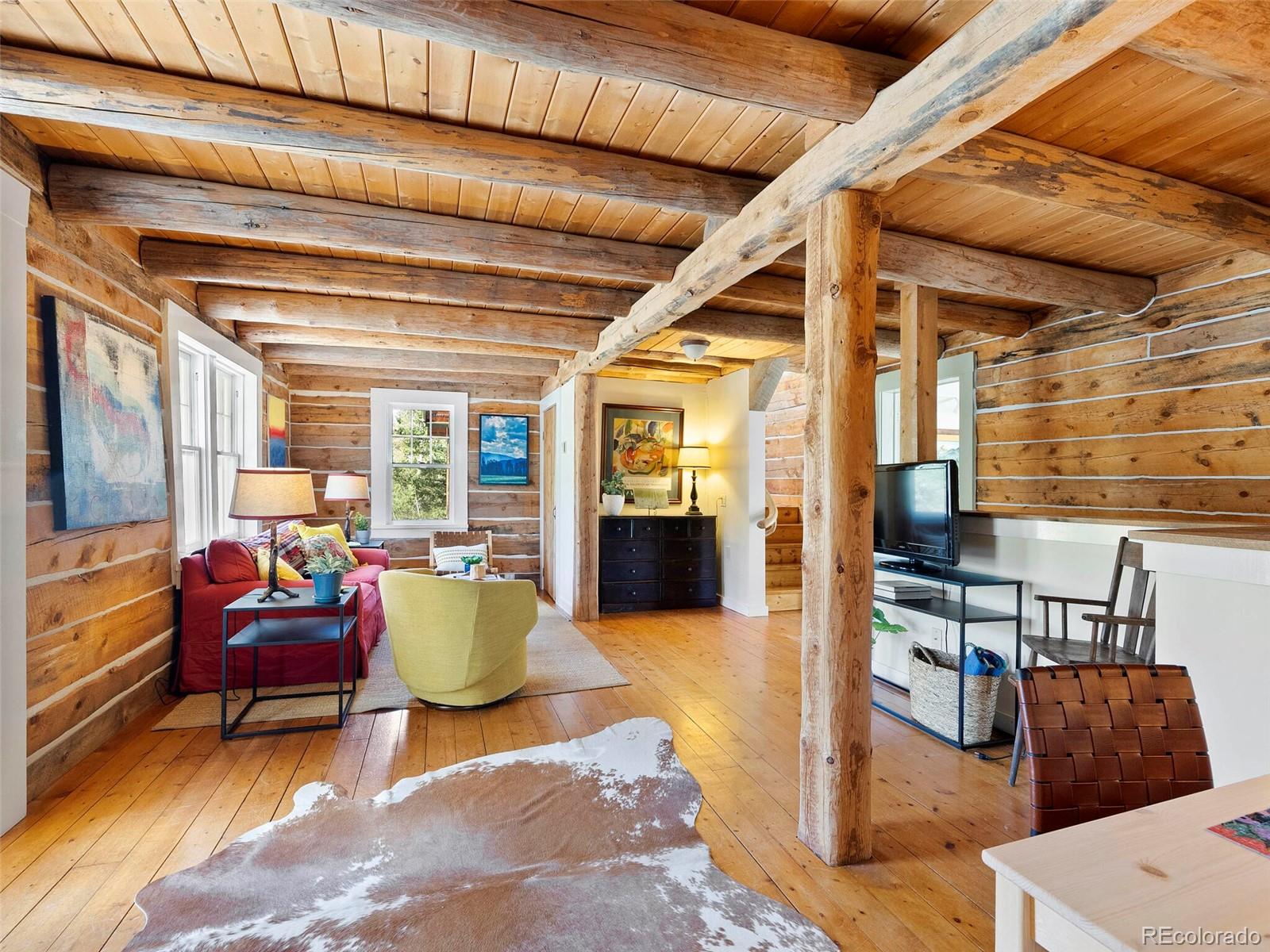 26795 Light Lane Conifer, CO 80433 - Photo 12 of 40 a living room with furniture and a floor to ceiling window