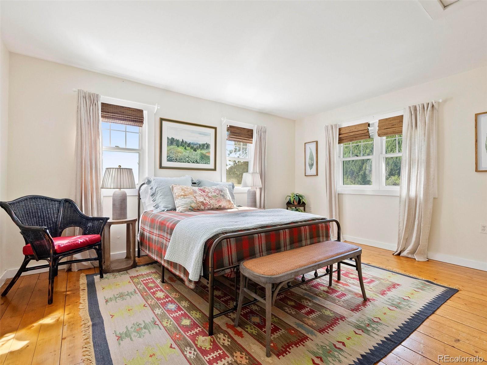 26795 Light Lane Conifer, CO 80433 - Photo 18 of 40 a bedroom with a bed a table and chair