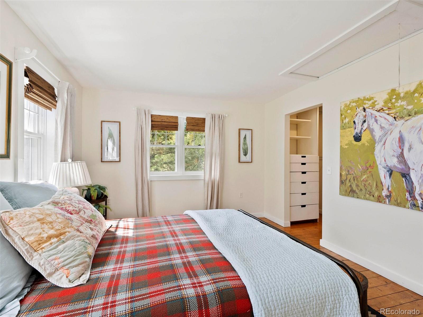 26795 Light Lane Conifer, CO 80433 - Photo 19 of 40 a bedroom with a bed and wooden floor