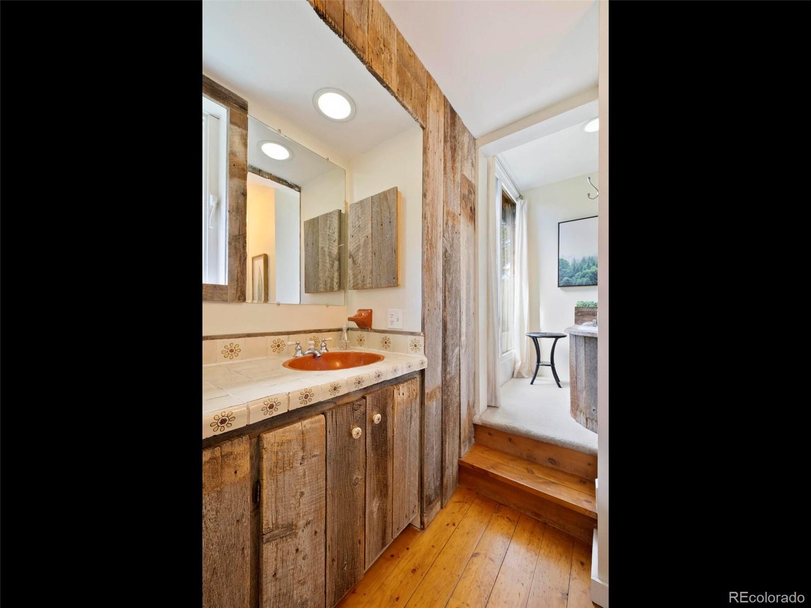 26795 Light Lane Conifer, CO 80433 - Photo 20 of 40 a bathroom with a sink and a mirror