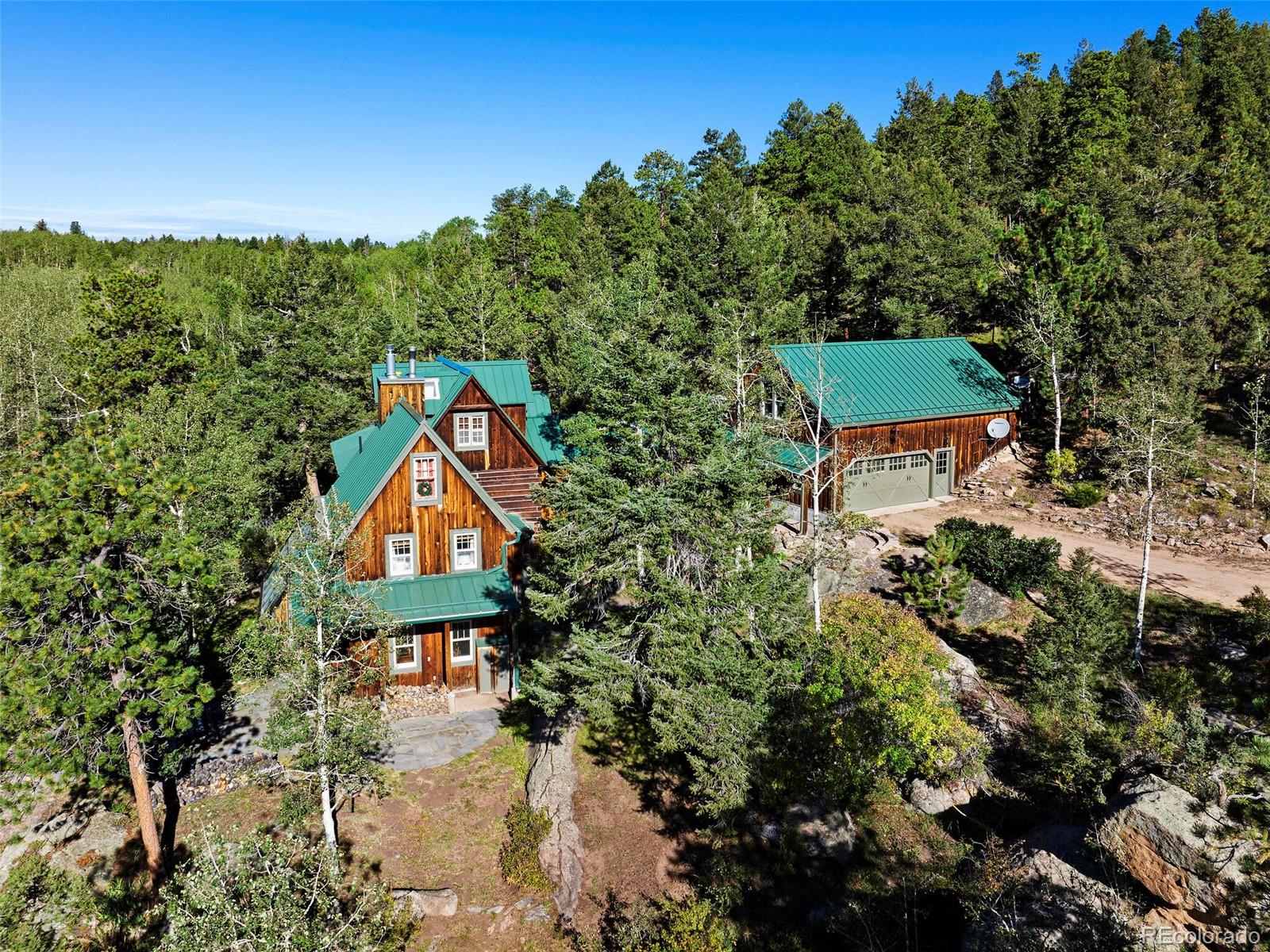 26795 Light Lane Conifer, CO 80433 - Photo 2 of 40 a sign that is sitting in front of a house