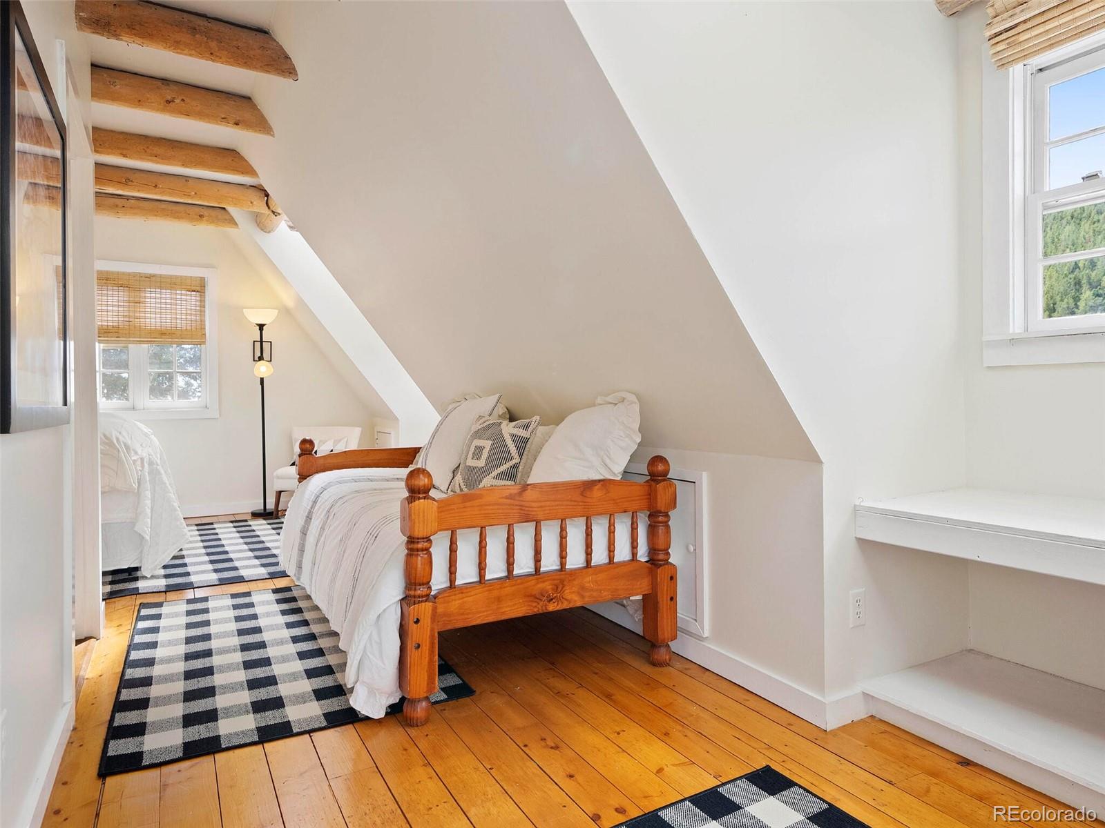 26795 Light Lane Conifer, CO 80433 - Photo 22 of 40 a bedroom with windows
