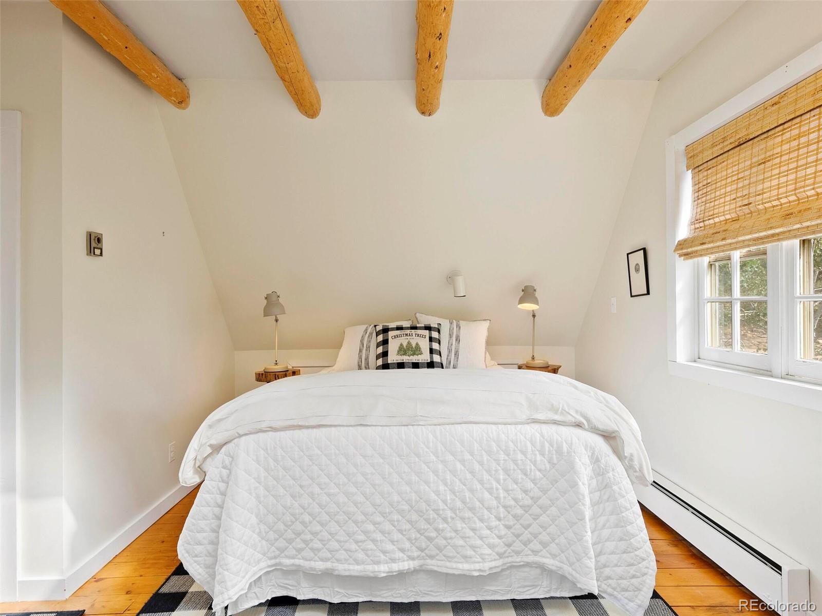 26795 Light Lane Conifer, CO 80433 - Photo 23 of 40 a bedroom with a bed and window