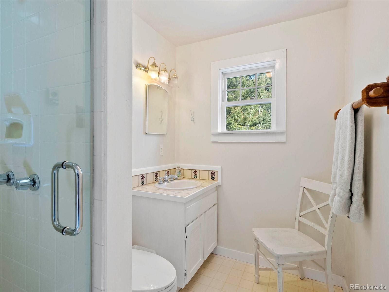 26795 Light Lane Conifer, CO 80433 - Photo 25 of 40 a bathroom with a sink toilet and a mirror