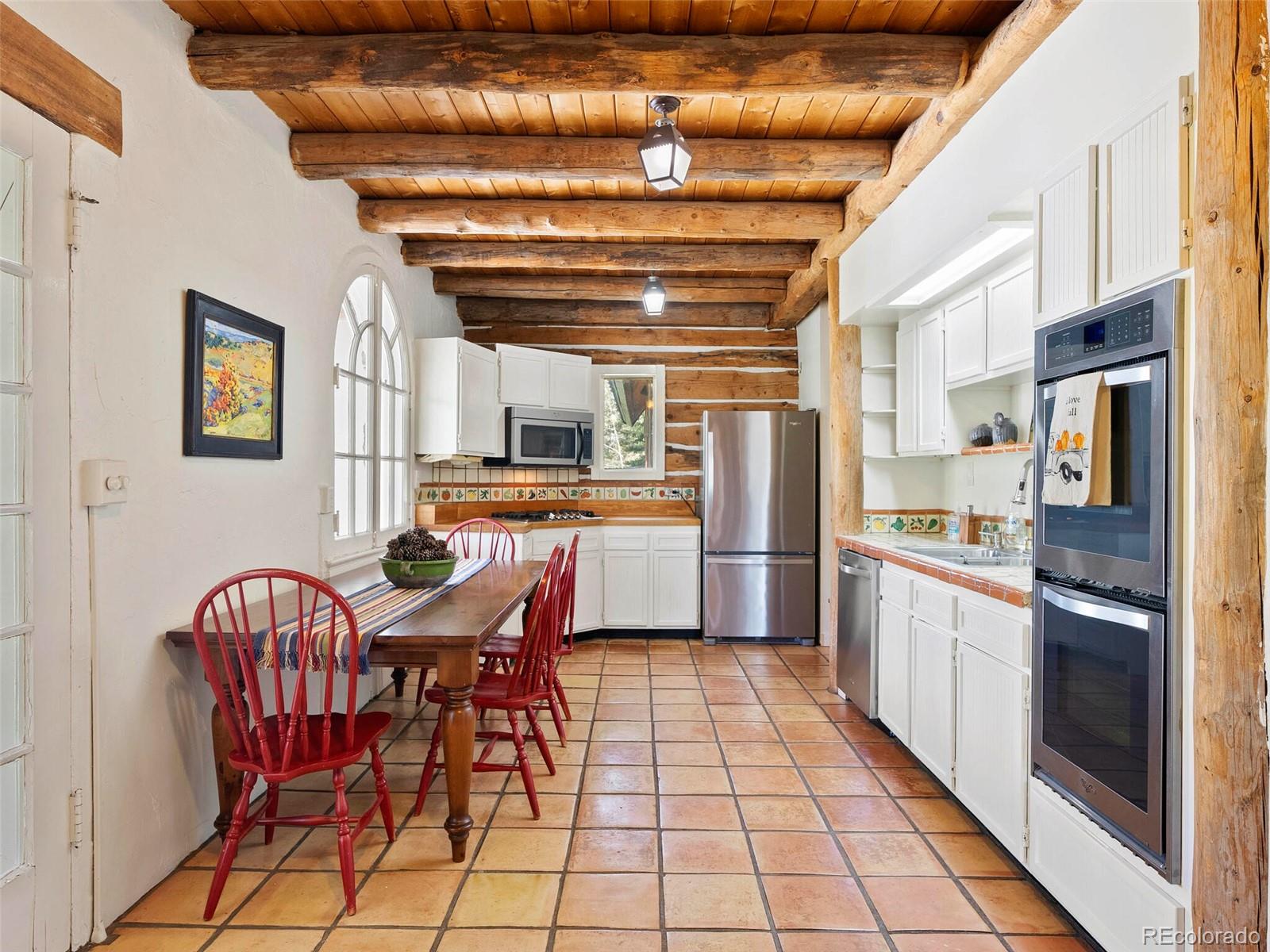 26795 Light Lane Conifer, CO 80433 - Photo 26 of 40 a kitchen with stainless steel appliances kitchen island granite countertop a refrigerator and microwave