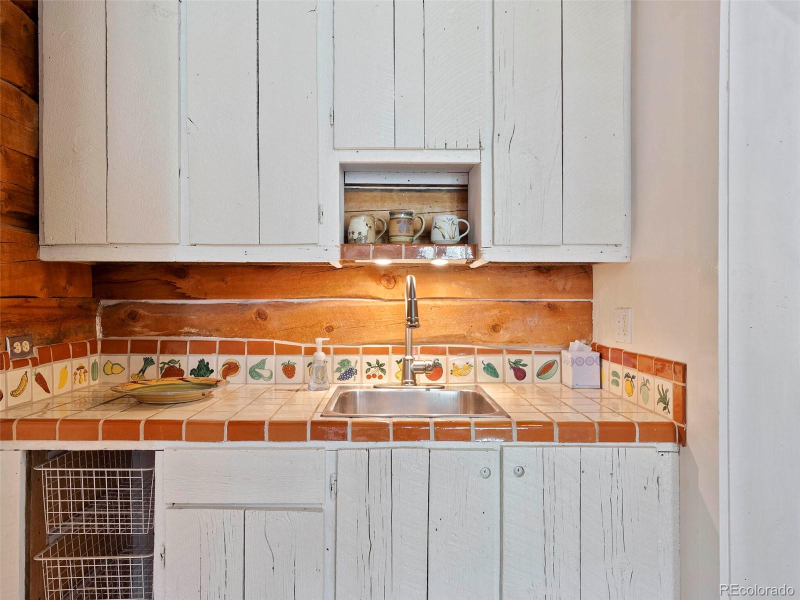 26795 Light Lane Conifer, CO 80433 - Photo 30 of 40 a kitchen with granite countertop white cabinets and sink