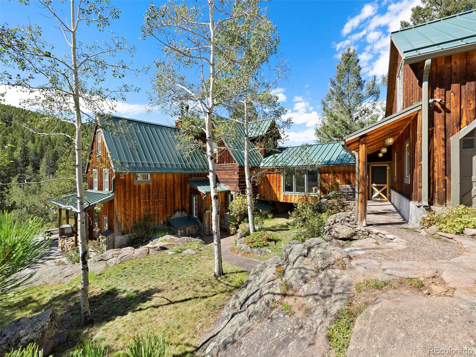 26795 Light Lane Conifer, CO 80433 - Photo 3 of 40 a view of house with a outdoor space