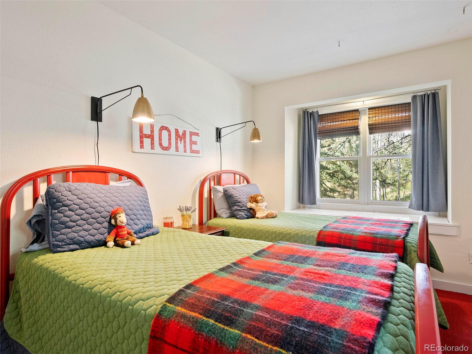 26795 Light Lane Conifer, CO 80433 - Photo 31 of 40 a bedroom with two beds and a window