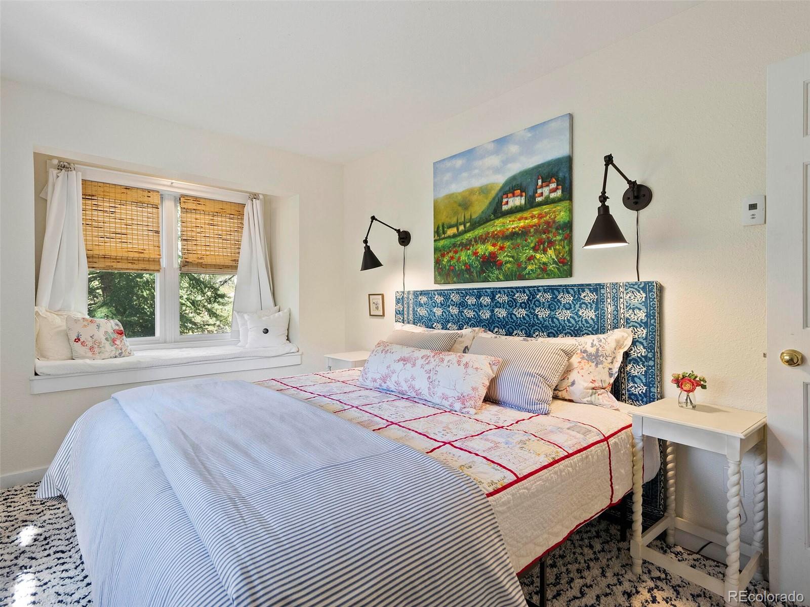 26795 Light Lane Conifer, CO 80433 - Photo 32 of 40 a bedroom with a bed and wooden floor