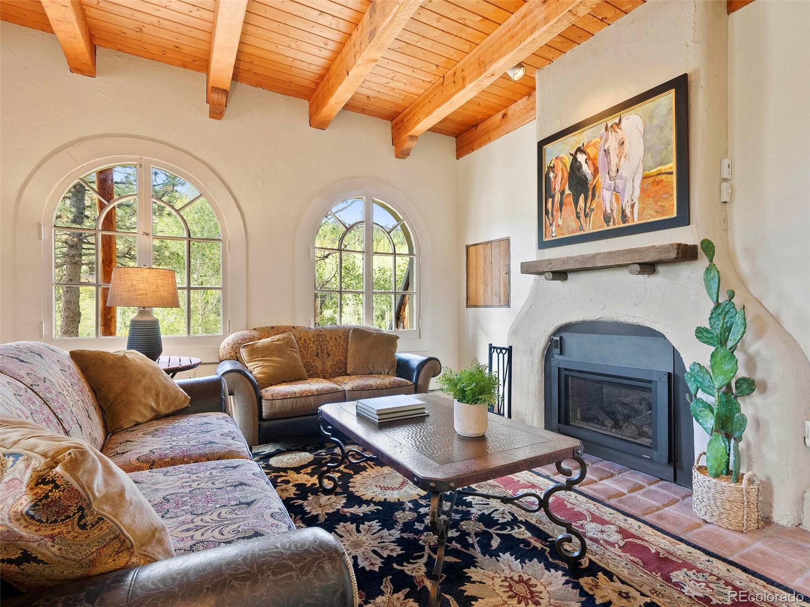 26795 Light Lane Conifer, CO 80433 - Photo 35 of 40 a living room with furniture a fireplace and a large window