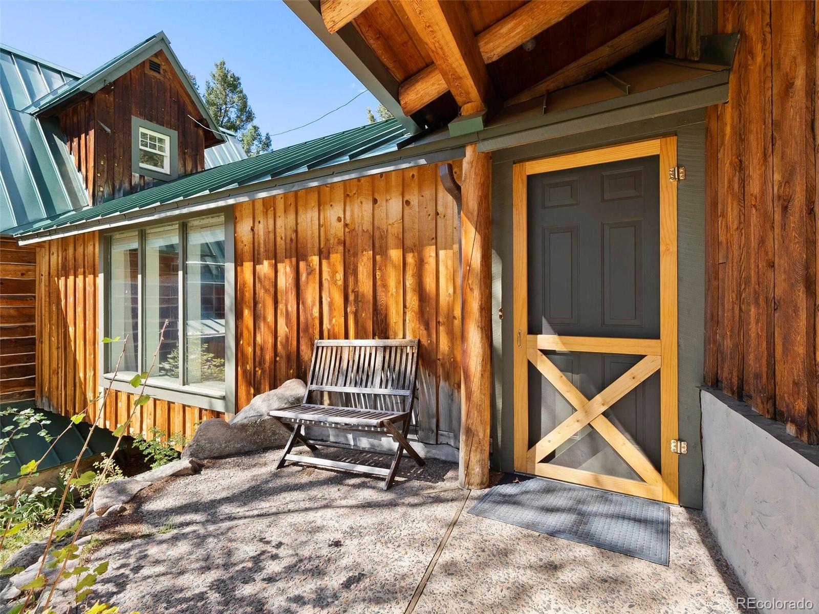 26795 Light Lane Conifer, CO 80433 - Photo 4 of 40 a view of wooden house with backyard and wooden fence