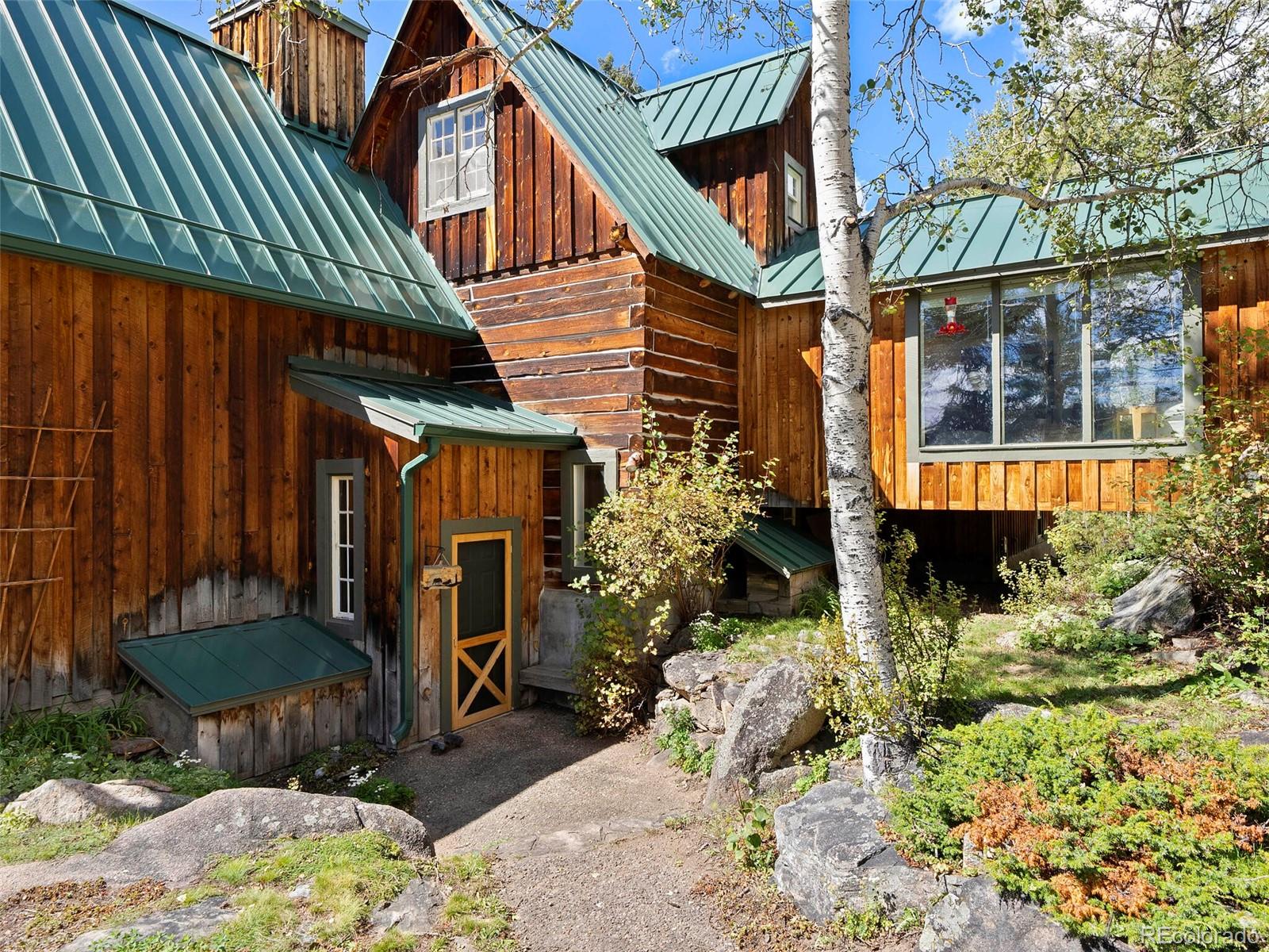 26795 Light Lane Conifer, CO 80433 - Photo 6 of 40 a view of a chair and table in backyard