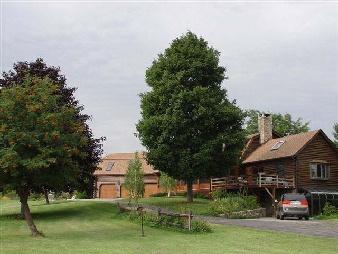 332 Weed Mine Road Copake, NY 12516 - Photo 1 of 2 a front view of a house with a garden