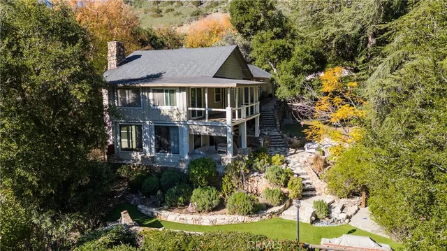 a front view of a house with a yard and fountain
