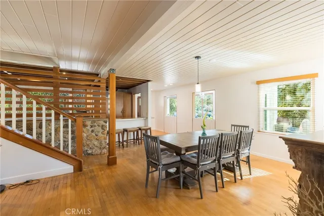 a living room with a couch and a dresser next to a window