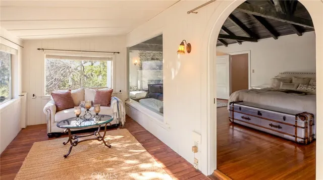 a view of a hallway with wooden floor and entryway