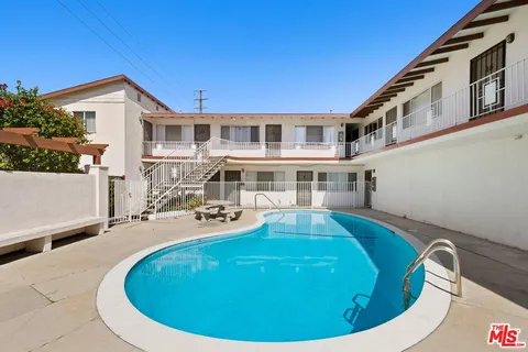 a view of a house with pool and chairs