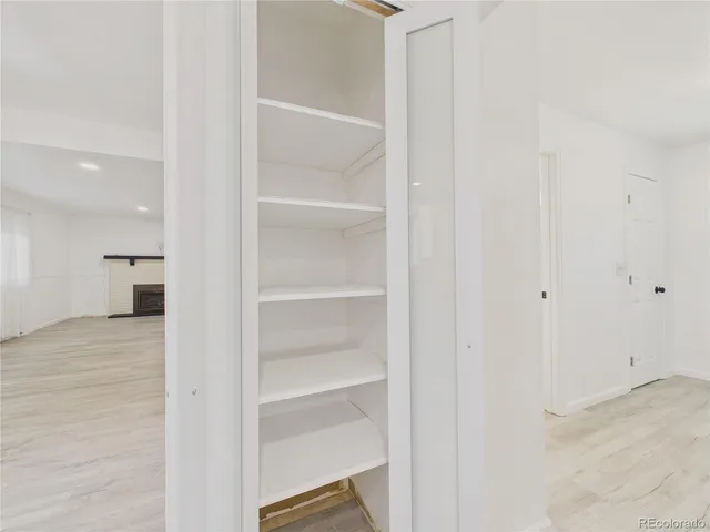 a view of walk in closet with empty racks